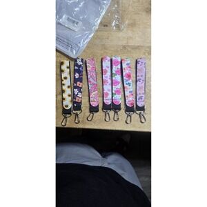 Set Of 7 fabric keychain wristlets feature various floral and paisley patterns